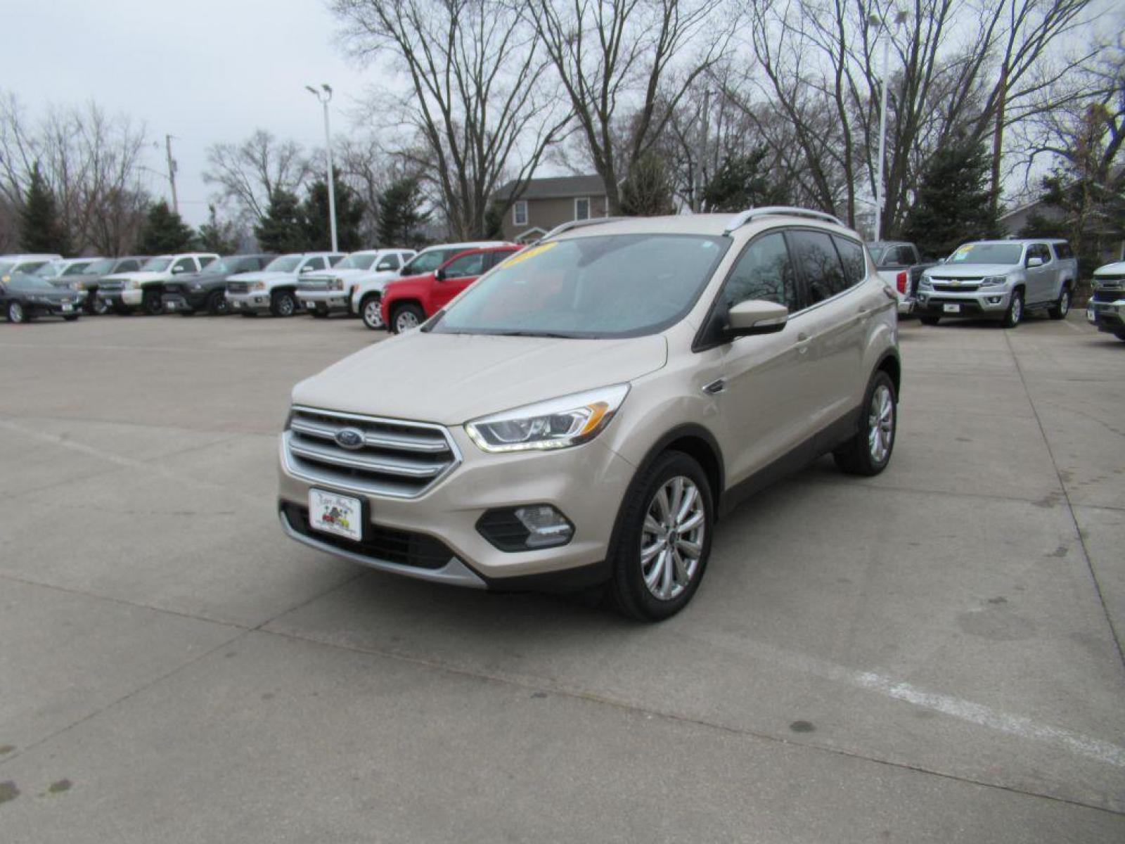 2017 GOLD FORD ESCAPE TITANIUM (1FMCU9JD4HU) with an 1.5L engine, Automatic transmission, located at 908 SE 14th Street, Des Moines, IA, 50317, (515) 281-0330, 41.580303, -93.597046 - Photo #0