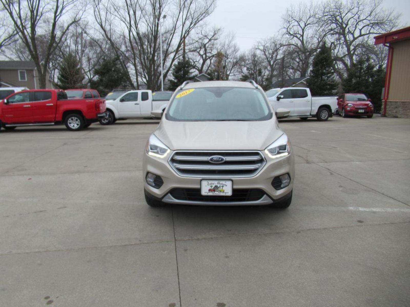 2017 GOLD FORD ESCAPE TITANIUM (1FMCU9JD4HU) with an 1.5L engine, Automatic transmission, located at 908 SE 14th Street, Des Moines, IA, 50317, (515) 281-0330, 41.580303, -93.597046 - Photo #1