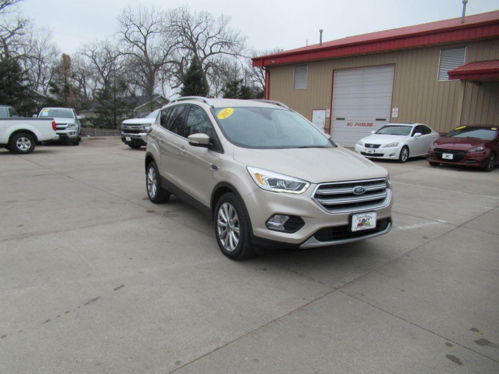 2017 GOLD FORD ESCAPE TITANIUM (1FMCU9JD4HU) with an 1.5L engine, Automatic transmission, located at 908 SE 14th Street, Des Moines, IA, 50317, (515) 281-0330, 41.580303, -93.597046 - Photo #2