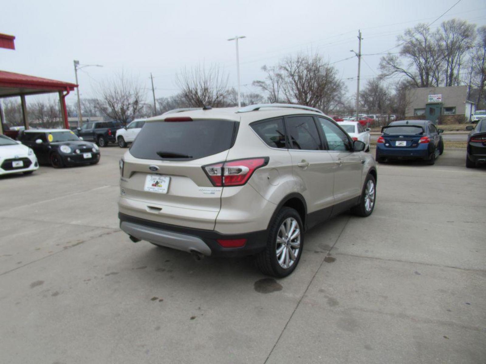 2017 GOLD FORD ESCAPE TITANIUM (1FMCU9JD4HU) with an 1.5L engine, Automatic transmission, located at 908 SE 14th Street, Des Moines, IA, 50317, (515) 281-0330, 41.580303, -93.597046 - Photo #4